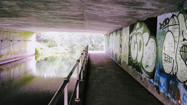 Itchen Navigation and Itchen Way pass under the M27. Graffiti on the underpass wall.