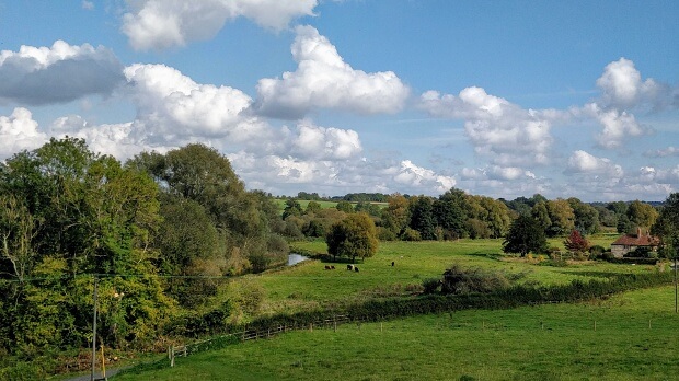 River valley, with view of river, grassland and trees. Looks like a Constable painting.